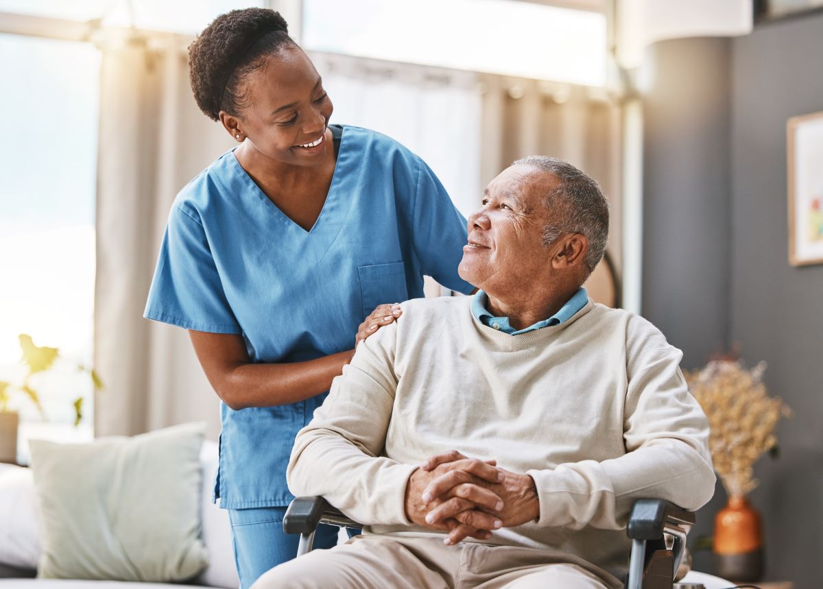 A nurse checks in on one of the residents at a nursing home.