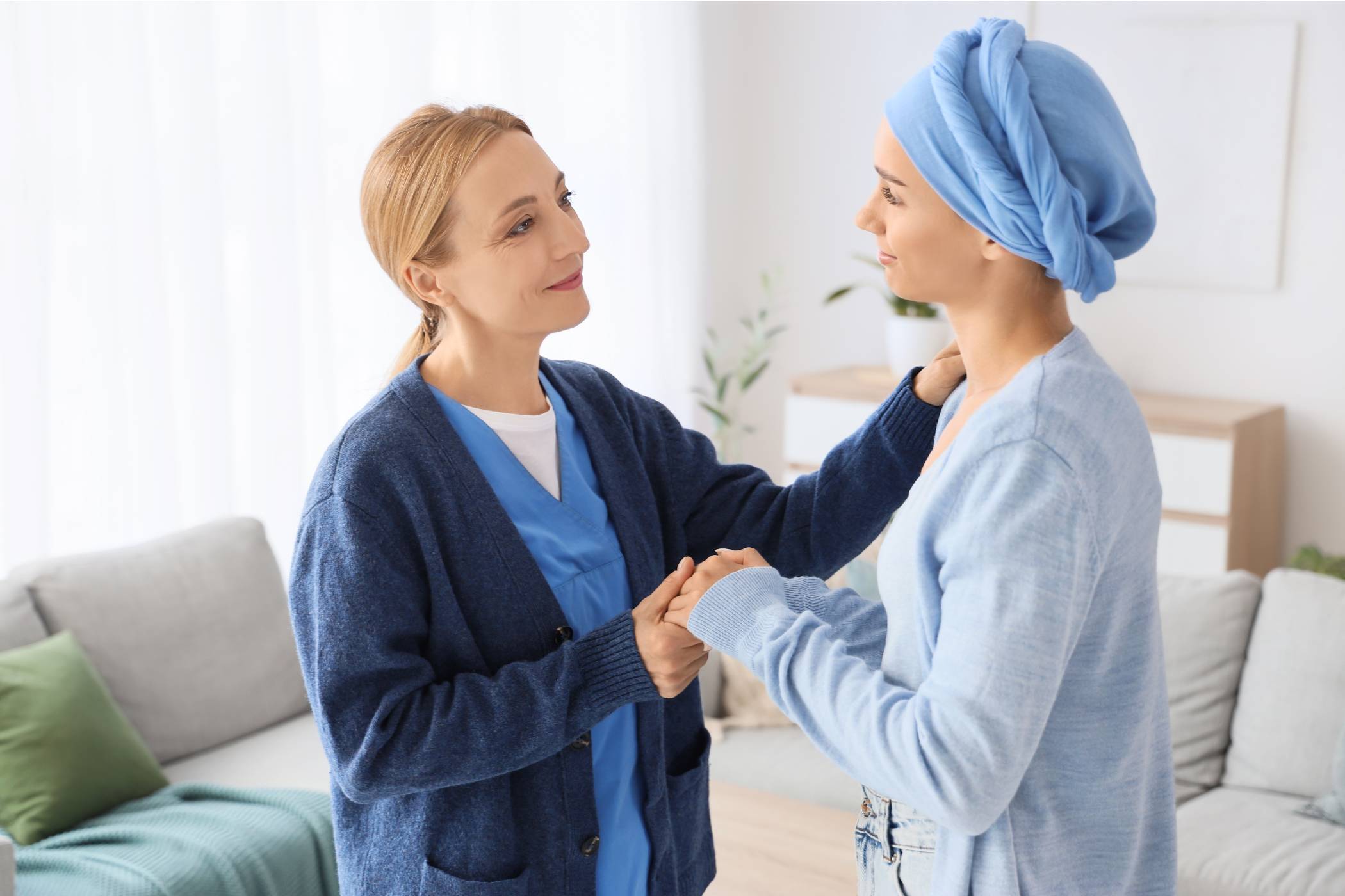 An oncology nurse navigator comforts an oncology patient.
