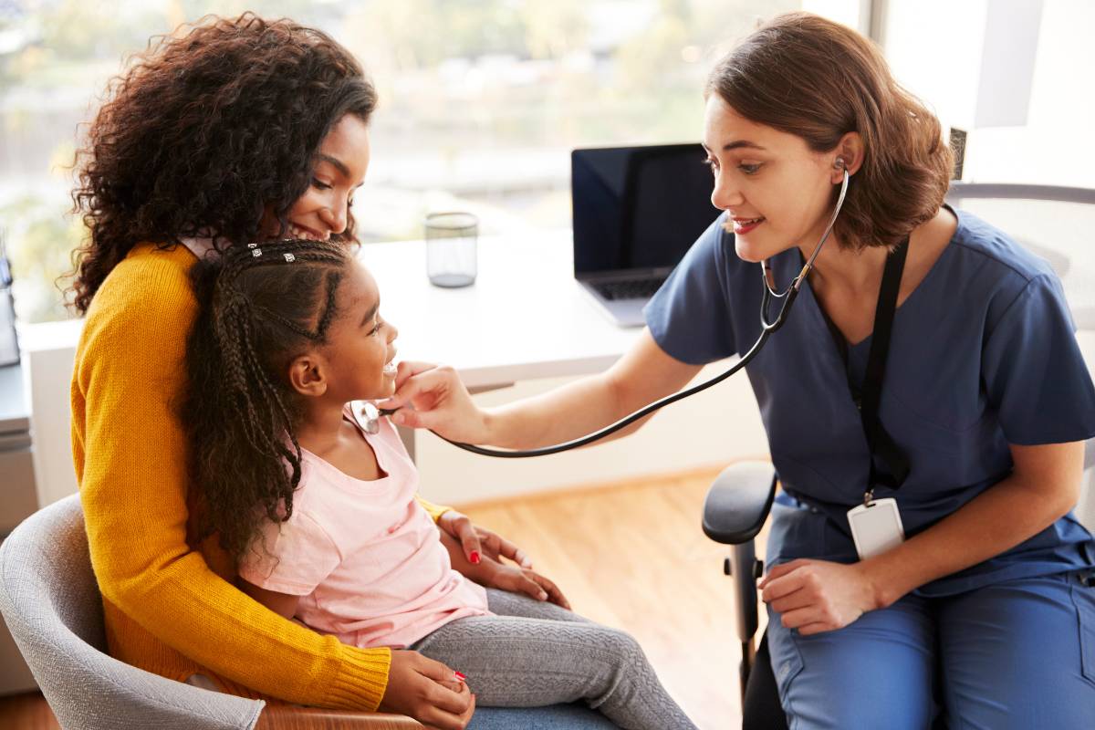 A pediatric nurse practitioner works with a patient.
