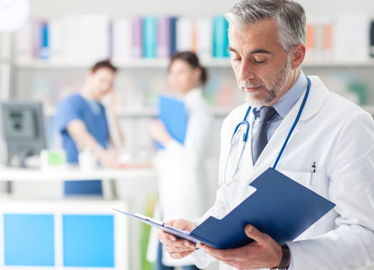 A physician looks at confidential patient information, mindful of Red Flags Rule protections.