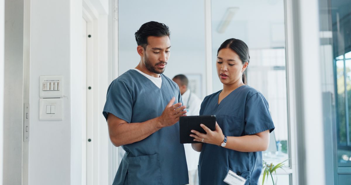 A registered nurse receives a performance evaluation from his supervisor.