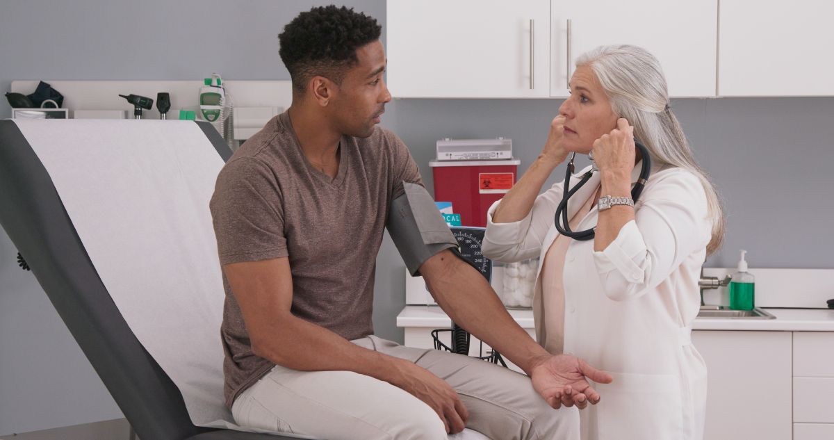 A patient in a Rhode Island medical clinic has his blood pressure checked by a physician.
