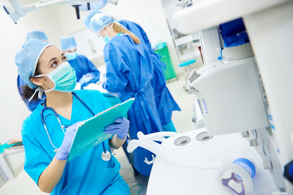 A nurse in the operating room checks her patient's chart.