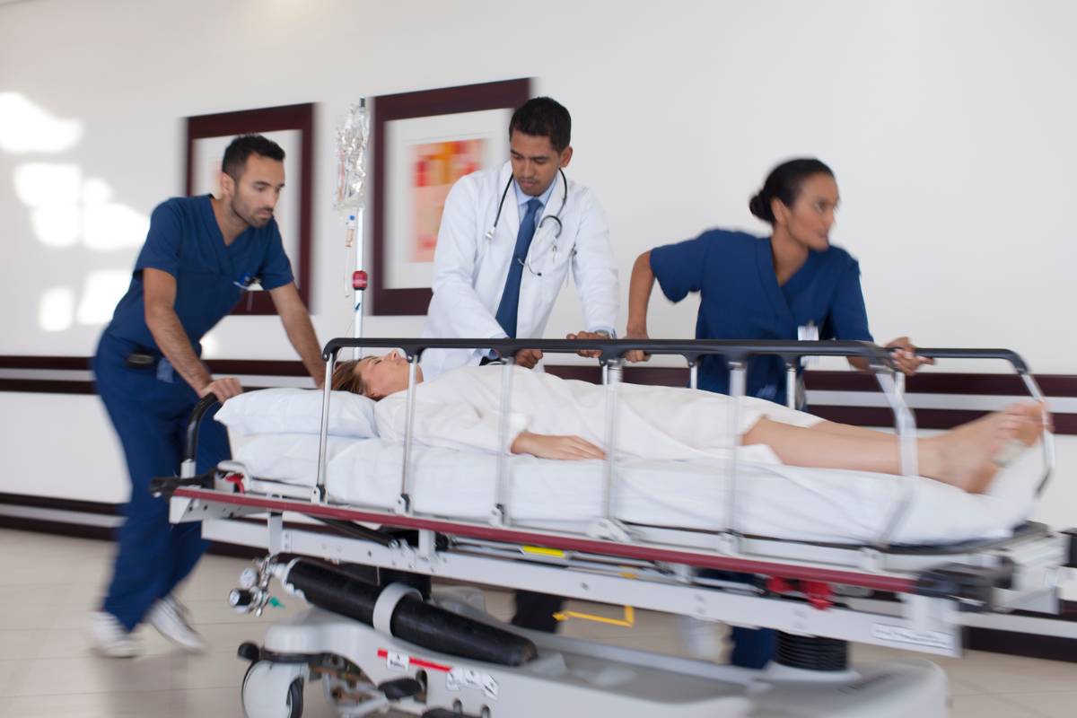 An RRT nurse rushes through a hospital hallway with the rapid response team.