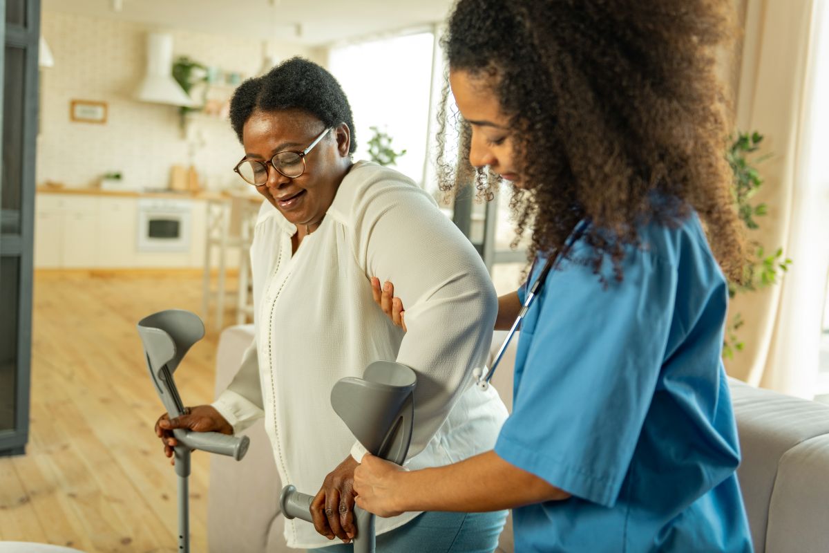 A nurse demonstrates safe patient handling as she helps one of her patients.