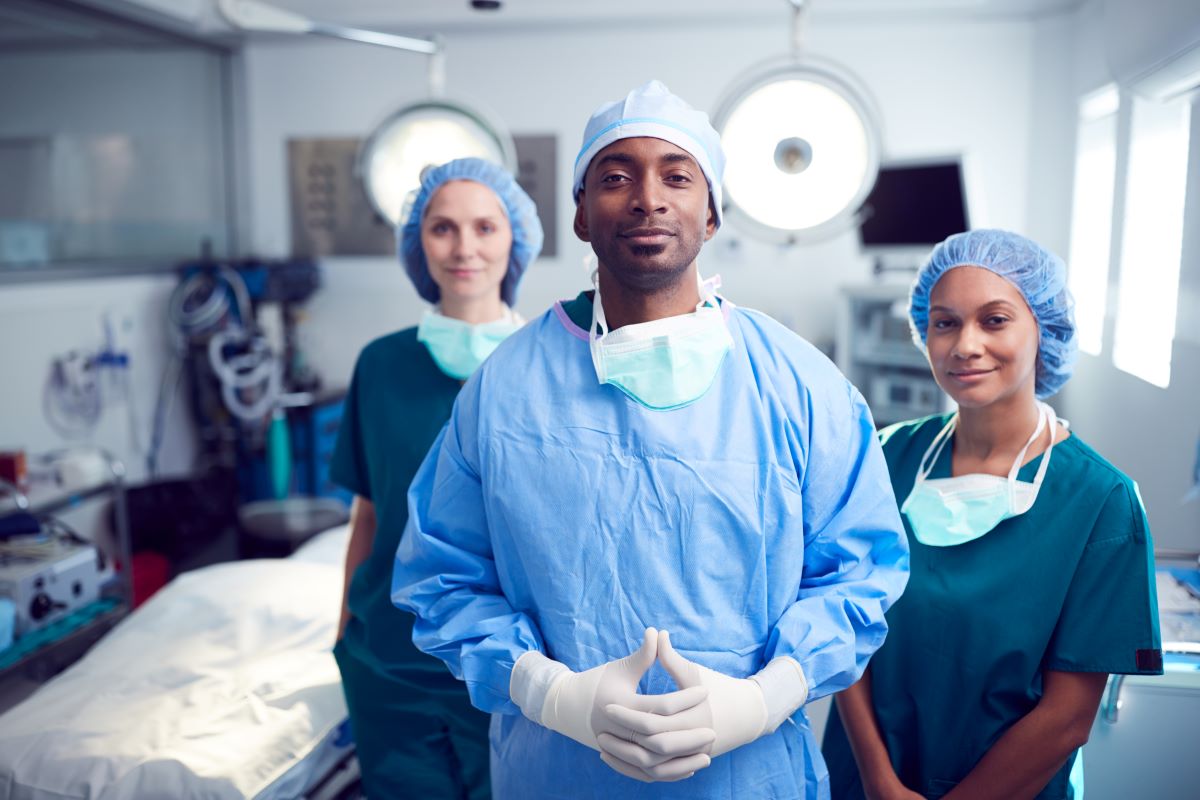 Three scrub nurses prepare for surgery.