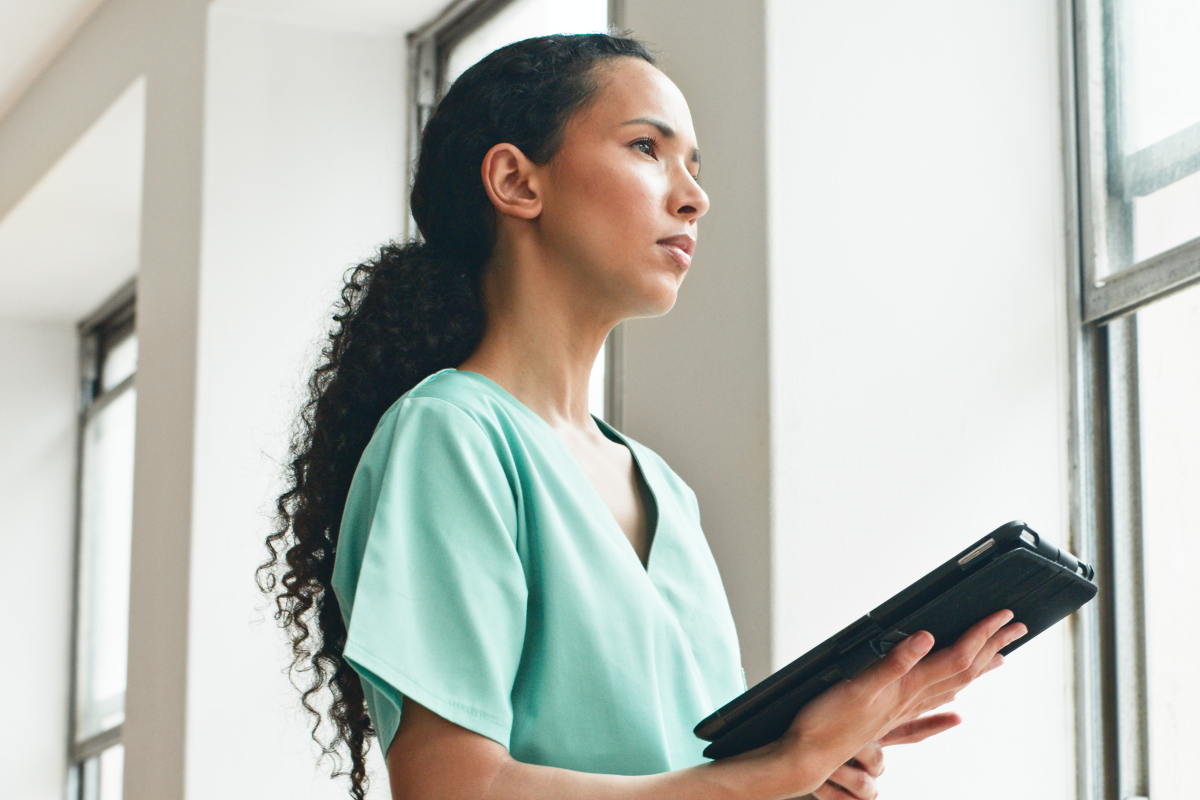 A nurse practicing self-reflection in nursing after a tough shift.