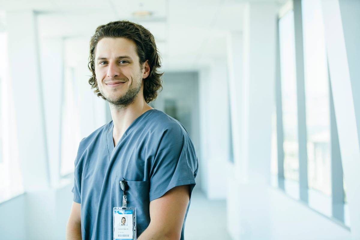 A substance abuse nurse stands in a hospital hallway.