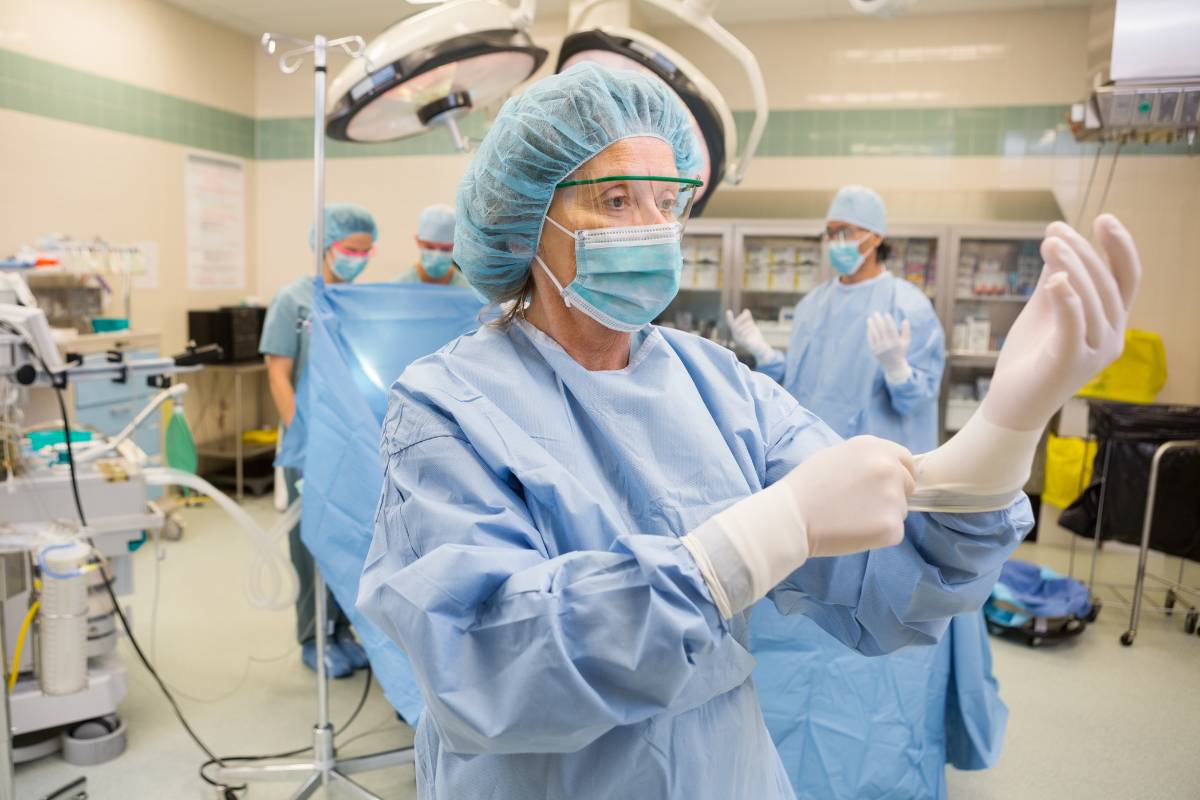 A healthcare worker with surgical tech certification prepares for a surgery.
