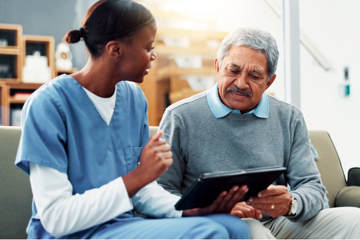 A nurse puts the Theory of Unpleasant Symptoms into practice while talking with a patient.