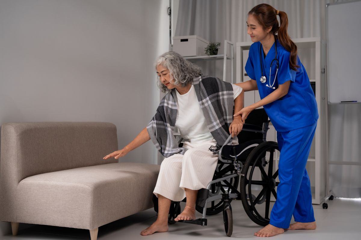 A nurse assists a patient who is about to be discharged and transitioned to a new facility.