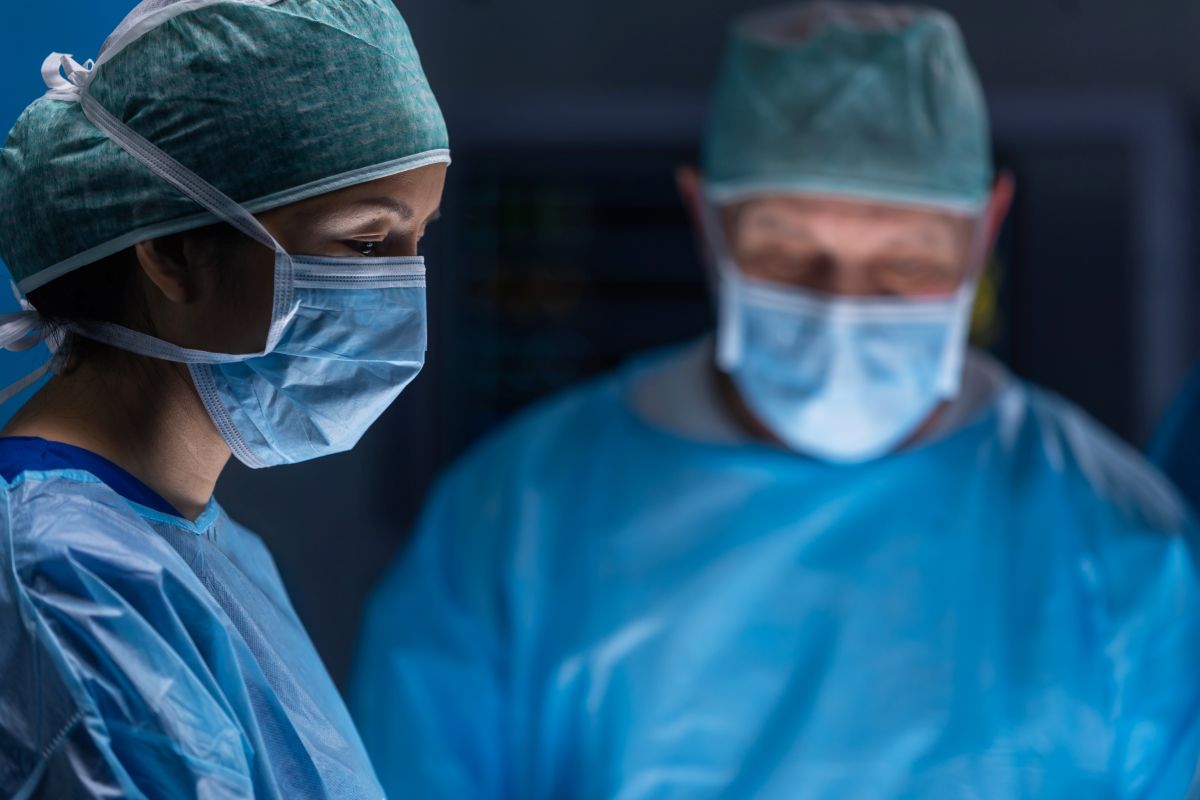 A transplant nurse assists the surgeon during an organ transplant.