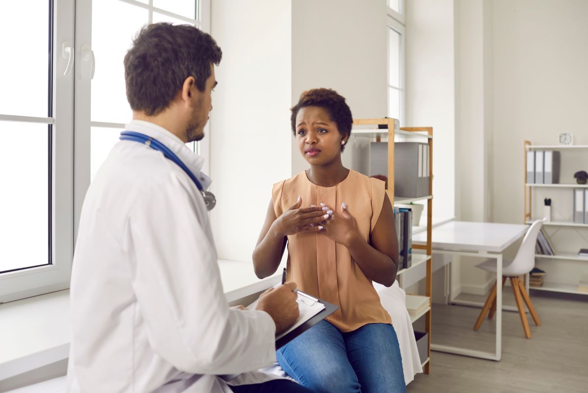 A nurse consoles a patient who is dealing with past trauma.