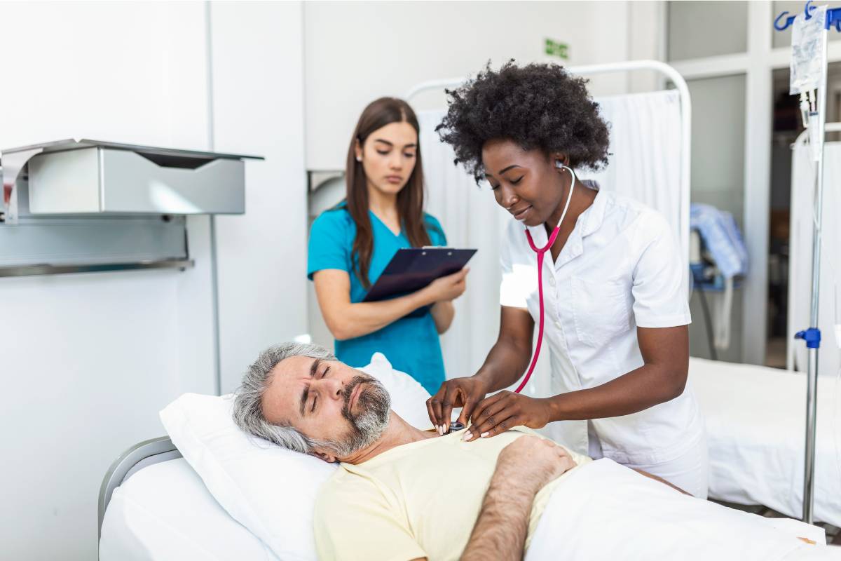 A trauma nurse practitioner assesses a patient's pulse in the emergency room.