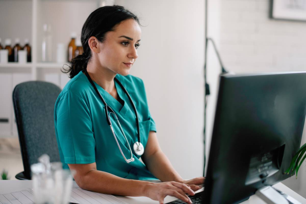 A nurse works on her utilization review nurse resume.