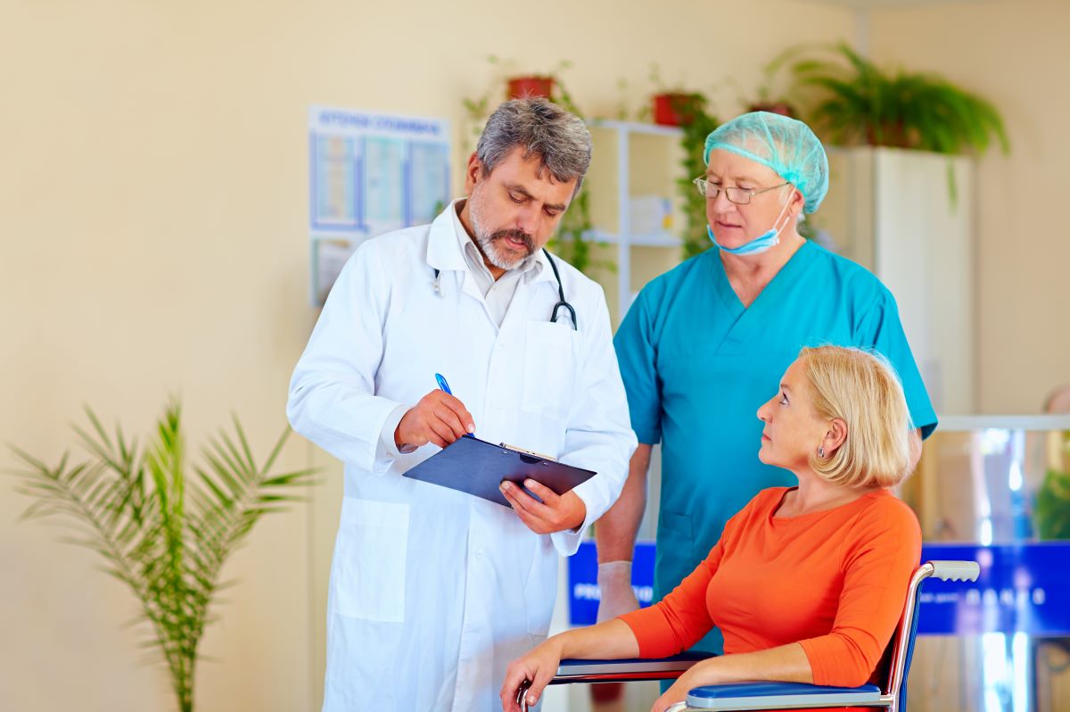 A doctor and a nurse discharge a patient from a hospital.
