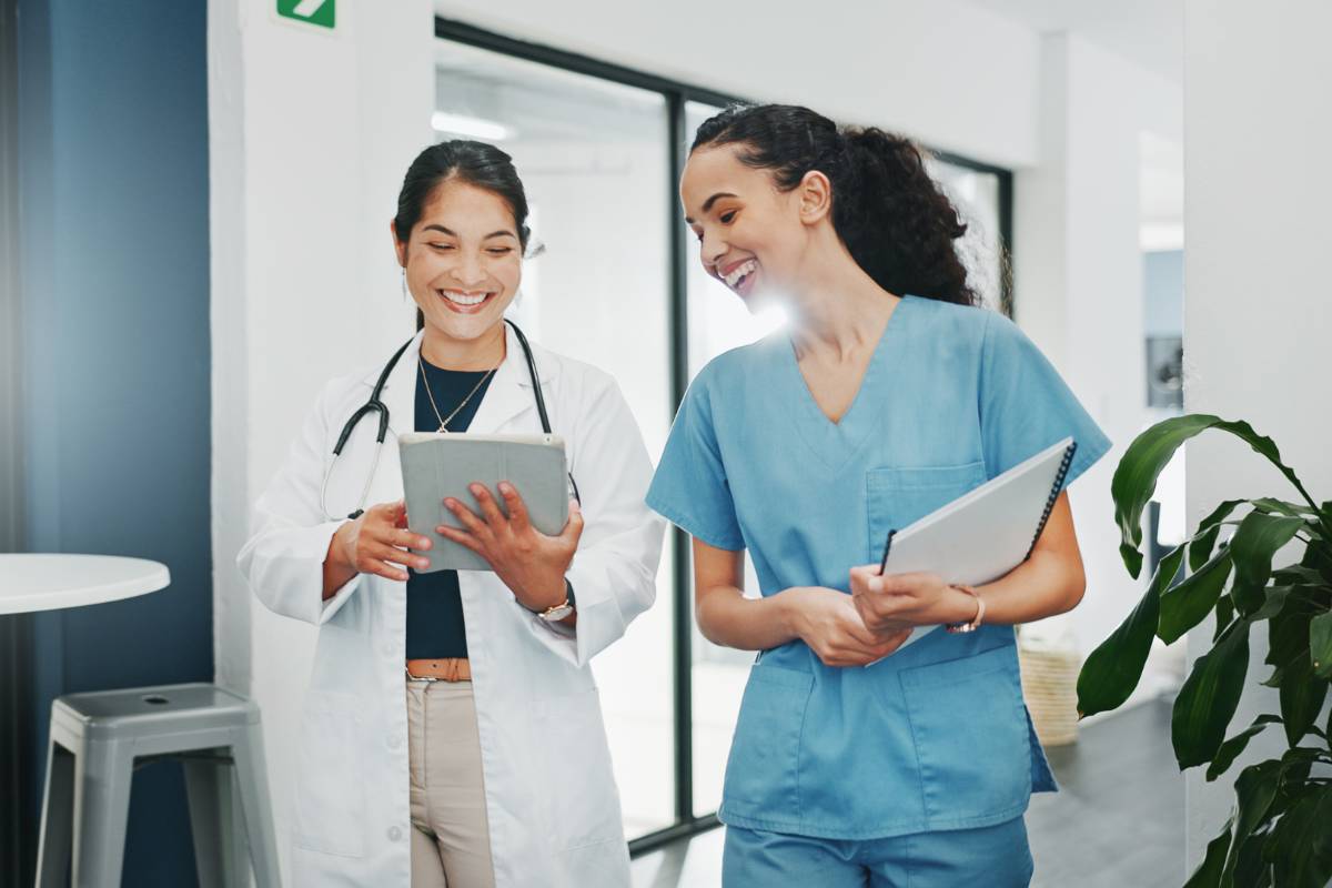 A nurse and doctor walk together and discuss the question, Where do nurses work?